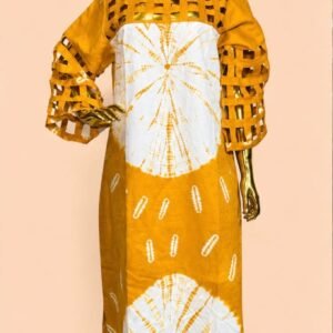 Exquisite African-inspired long dress with intricate white designs on a golden yellow background, showcased on a luxurious gold mannequin.