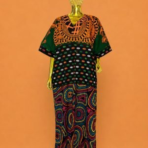 A gold mannequin wearing a vibrant, traditional African dashiki with intricate patterns and designs.